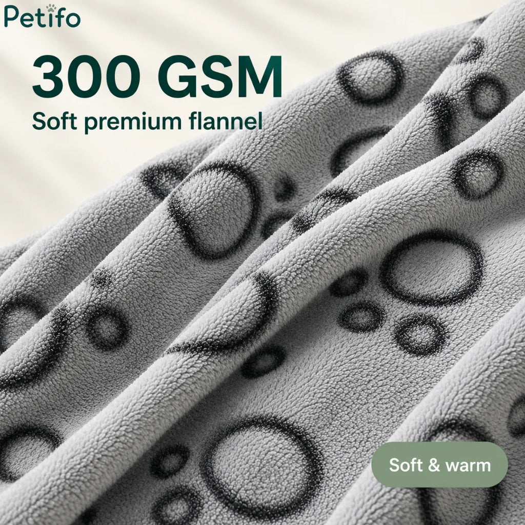 Close-up texture view of the 300 GSM soft premium flannel material featuring a grey paw-print pattern.