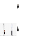 Black charging cable shown alongside two white electric pet grooming trimmers against a white background.