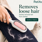 Person using Petifo brush to remove loose cat hair from dark denim jeans