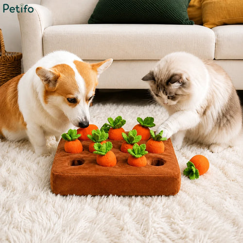 Dog and cat playing with the Petifo carrot harvest puzzle toy on a cozy white rug in a living room.