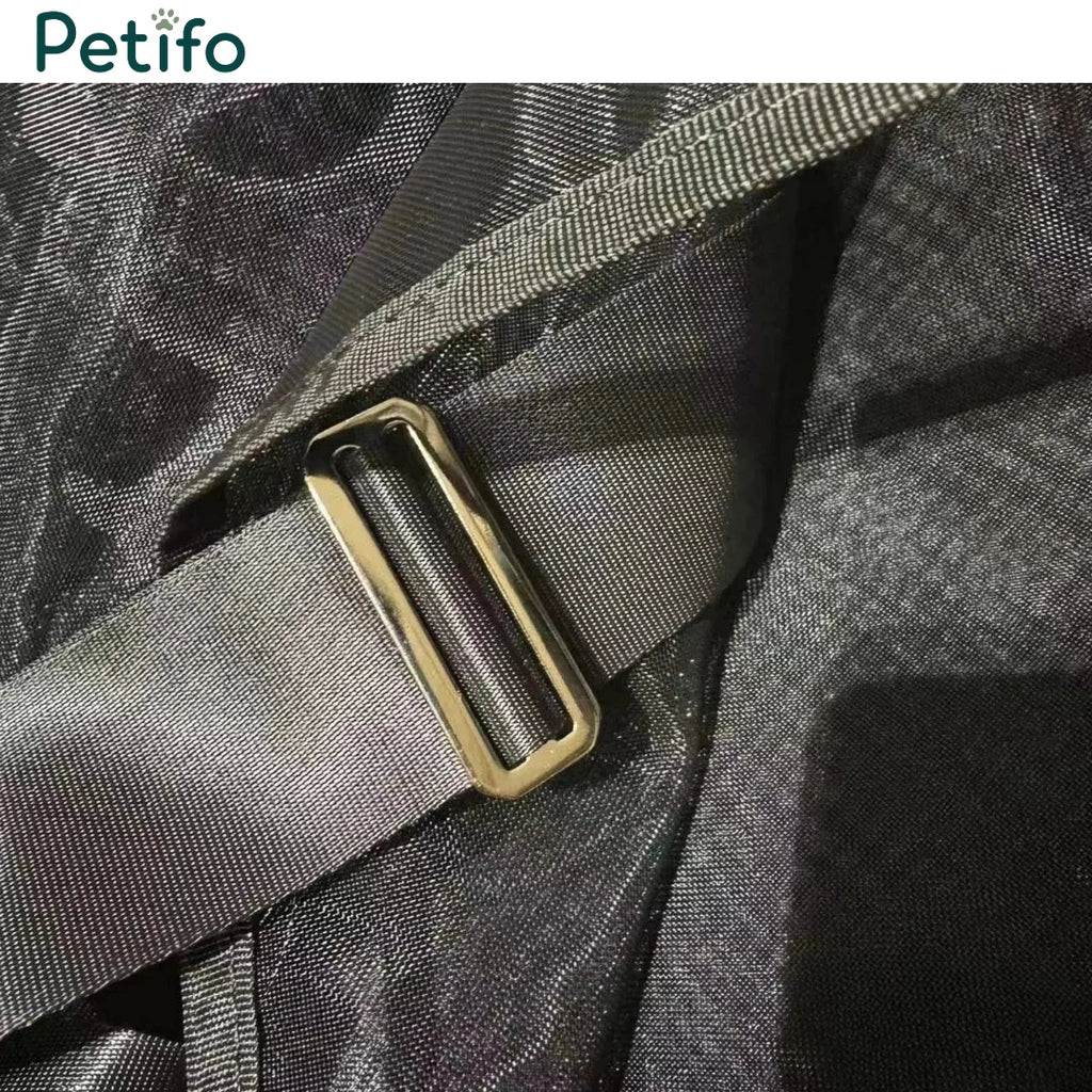 Detail shot of a durable strap and metallic adjustment buckle on a black mesh horse rug.