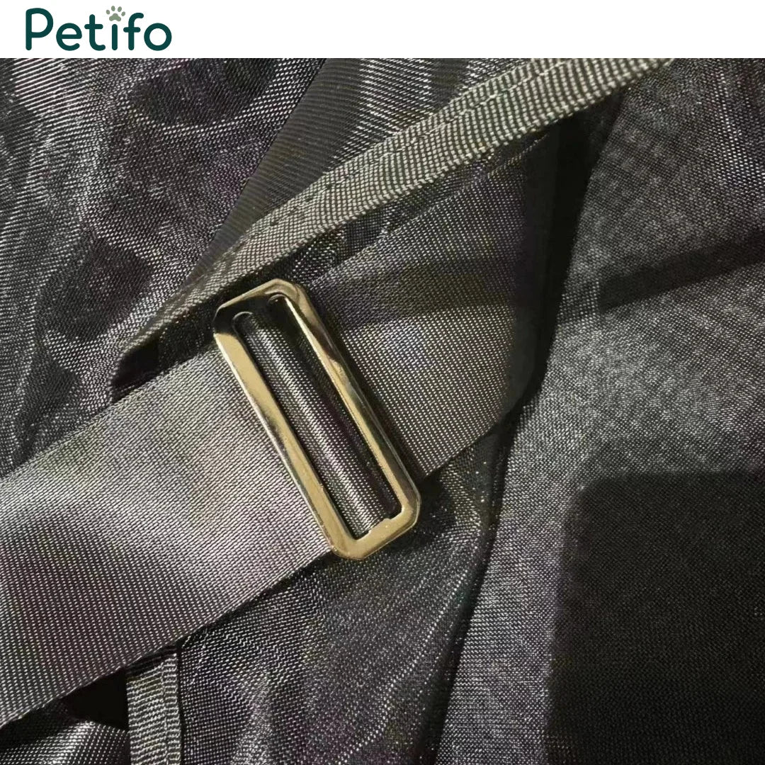 Detail shot of a durable strap and metallic adjustment buckle on a black mesh horse rug.