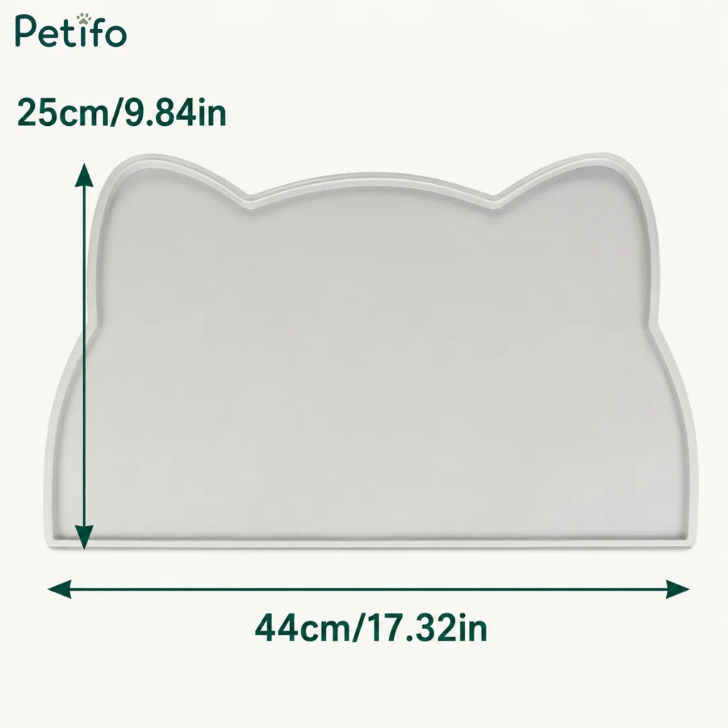 Dimension diagram of the cat-ear-shaped gray silicone pet mat showing measurements of 44 cm / 17.32 in wide and 25 cm / 9.84 in tall.