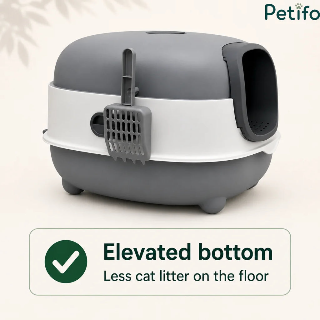 Side view of the grey and white covered litter box highlighting its elevated bottom and attached hanging scoop.