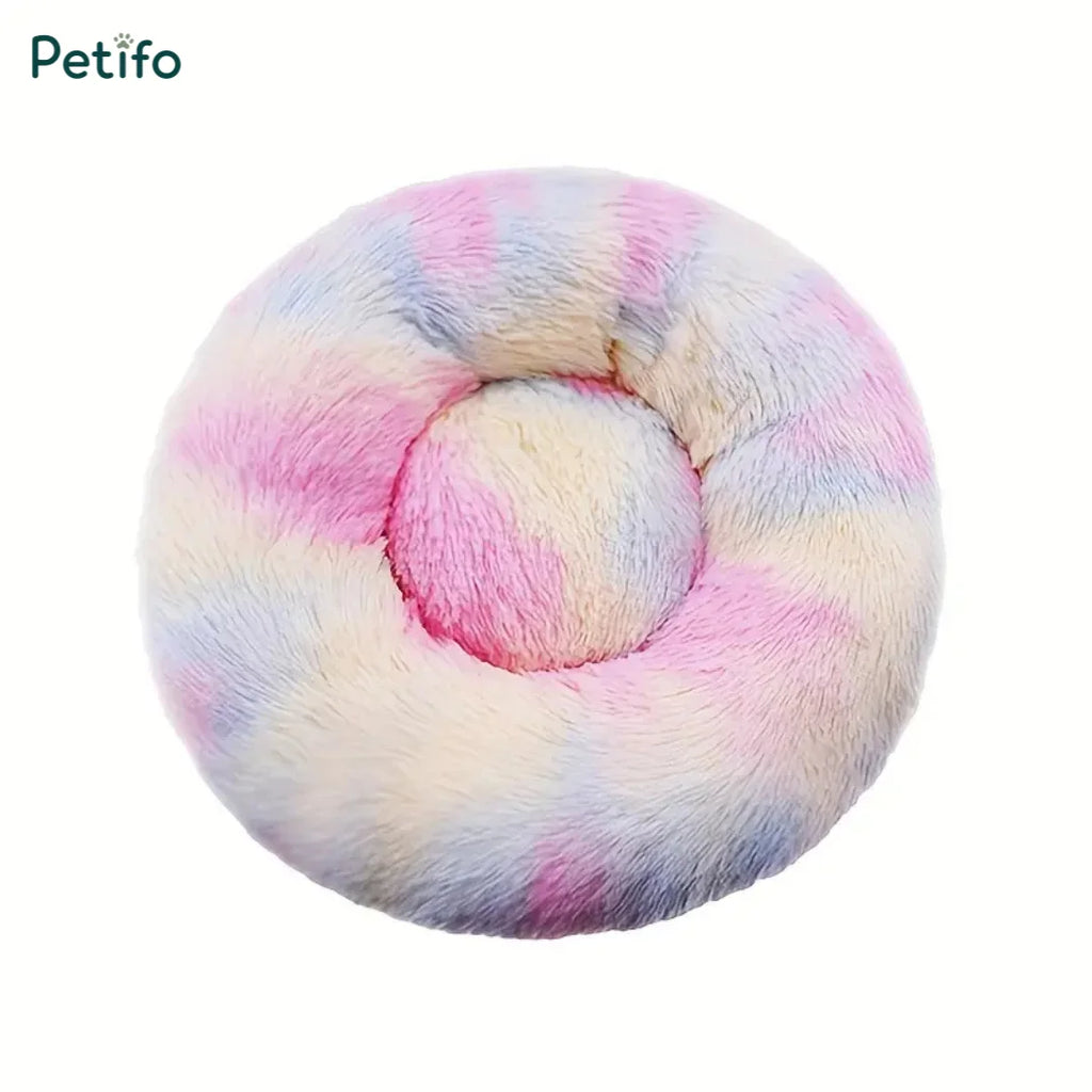 Pastel tie-dye multi-colored round fluffy plush pet bed viewed from above.