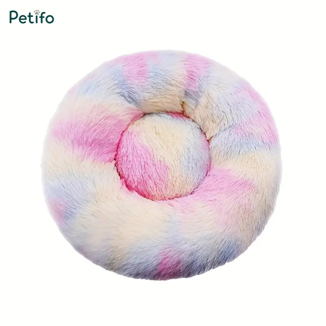 Pastel tie-dye multi-colored round fluffy plush pet bed viewed from above.