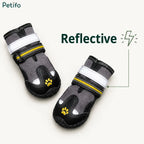 Pair of reflective grey and black dog boots designed for safe nighttime walking.