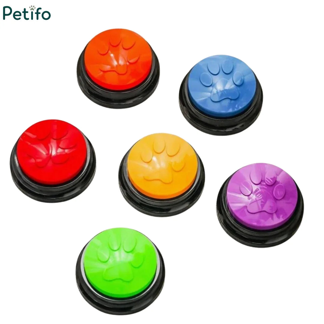 Assorted colorful recordable dog communication buttons featuring paw prints arranged on a white background.