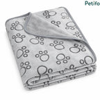 Folded grey fleece puppy blanket featuring a cute paw print pattern and smooth piped edging.
