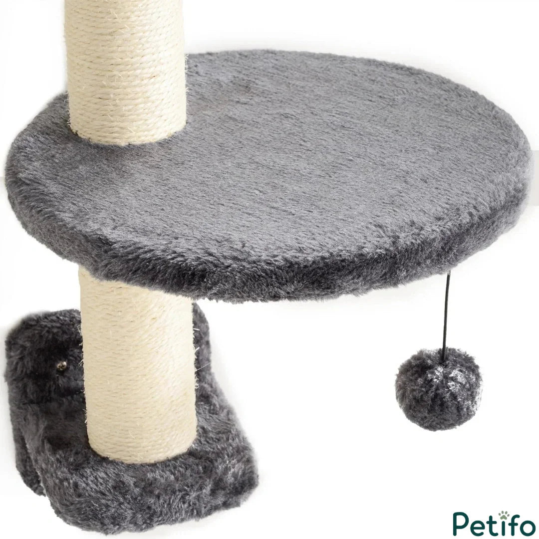 Close-up of a wall-mounted gray cat platform featuring a sisal scratching post and a hanging plush toy ball.