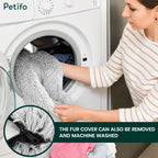 Woman loading the removable faux fur cover of a large dog bed into a washing machine.