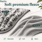 Reversible grey pet blanket displayed to highlight its soft patterned side and plain dyed side.