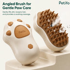 An angled view of the paw-shaped grooming brush highlighting its soft bristles, steam function, and ergonomic design.