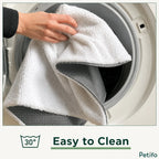 A hand placing the white and grey pet mat into a washing machine drum, with a "30°" washing icon and the text "Easy to Clean".