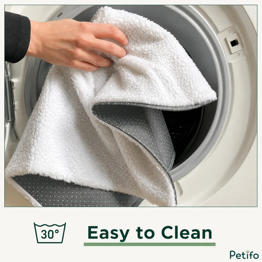 A hand placing the white and grey pet mat into a washing machine drum, with a "30°" washing icon and the text "Easy to Clean".