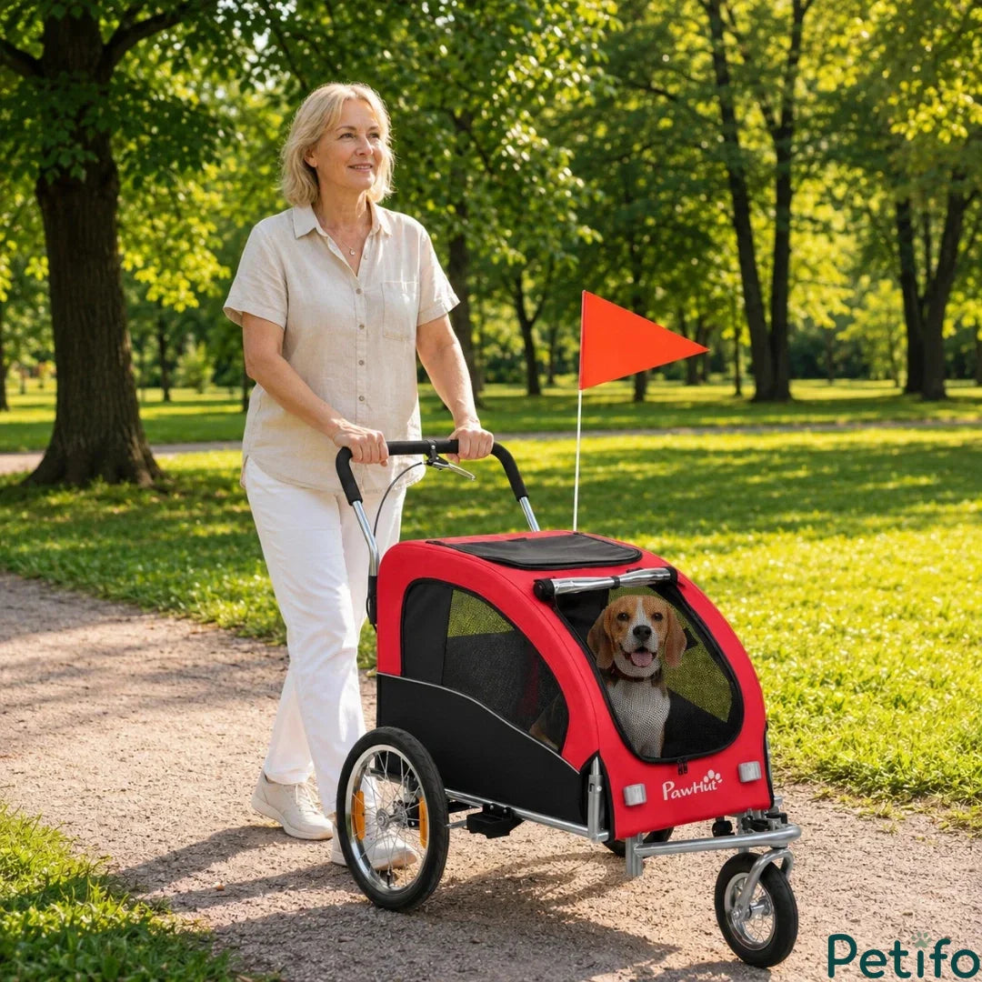 Woman comfortably walking on a park path while pushing the Petifo red pet stroller with a beagle inside.