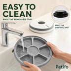 PawHut 6-meal pet feeder: Removable six-compartment food tray being rinsed clean - Petifo